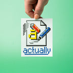 Hand holding a pixelated custom vinyl stickers with a colourful design and the word 'actually' on a green background.